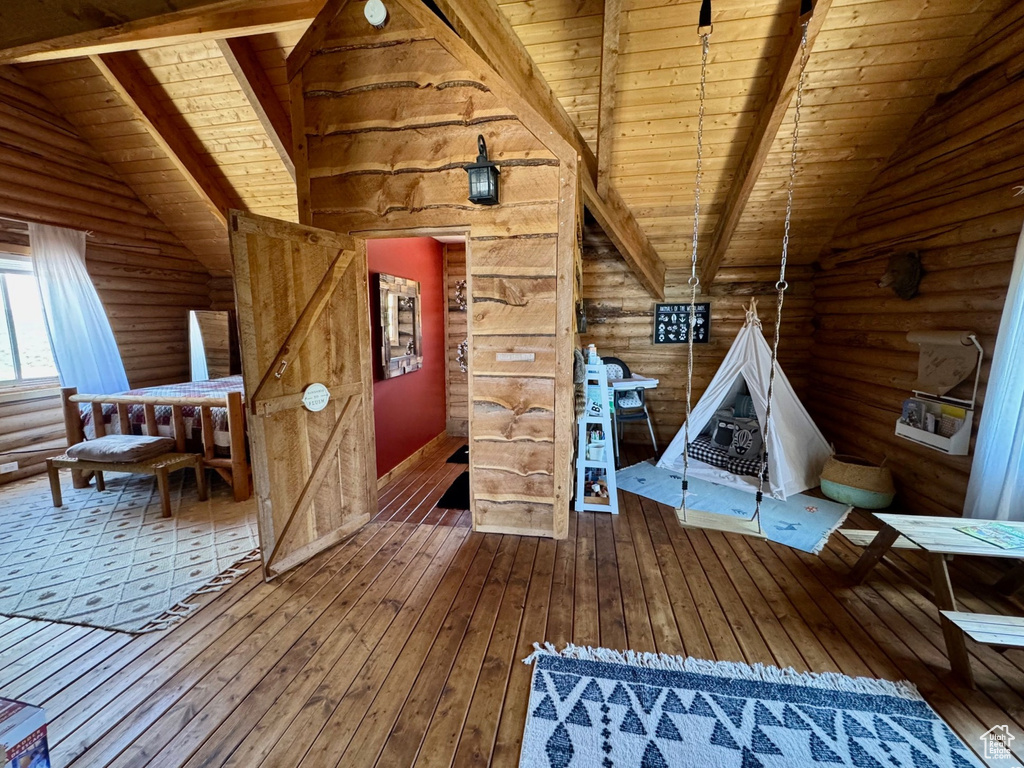 Sitting room featuring wooden ceiling, rustic walls, and hardwood / wood-style flooring