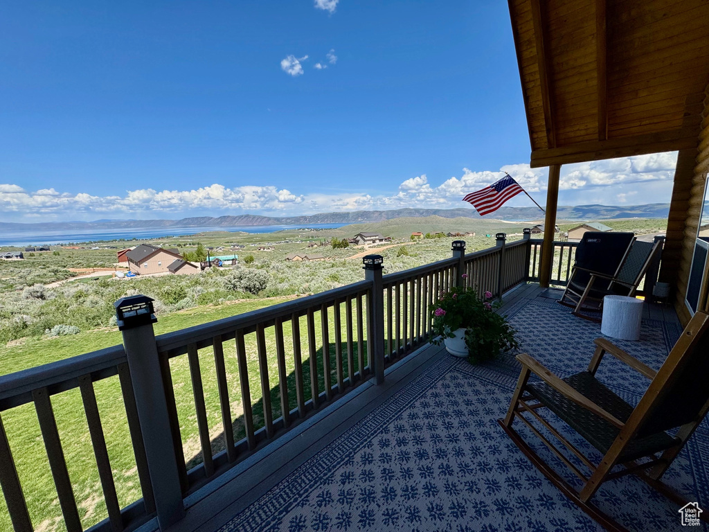 Deck featuring a mountain view and a yard