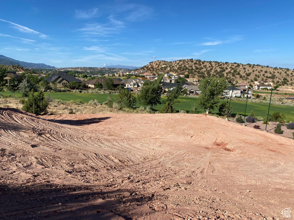 View of mountain backdrop featuring nearby suburban area
