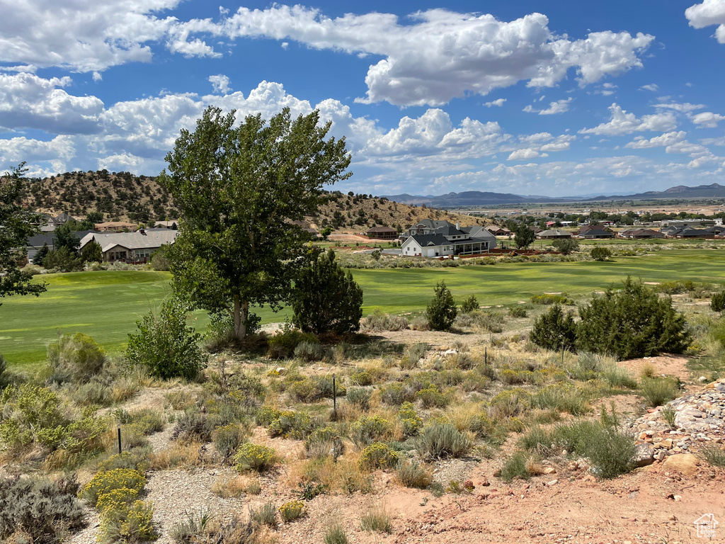 View of mountain backdrop with a local golf course and nearby suburban area