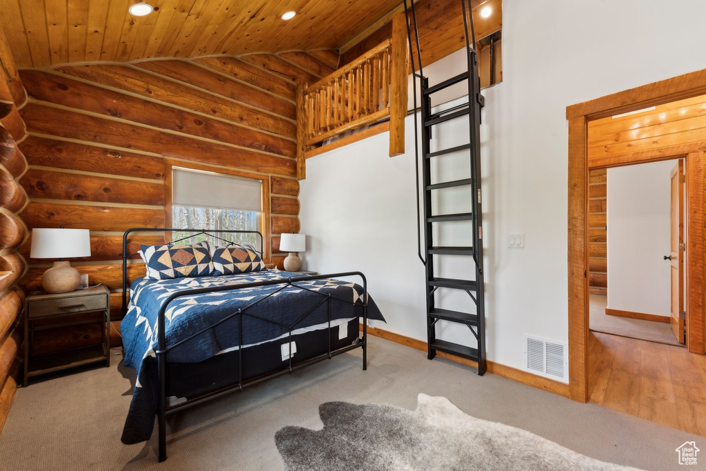 Bedroom with vaulted ceiling, wood ceiling, baseboards, recessed lighting, and log walls