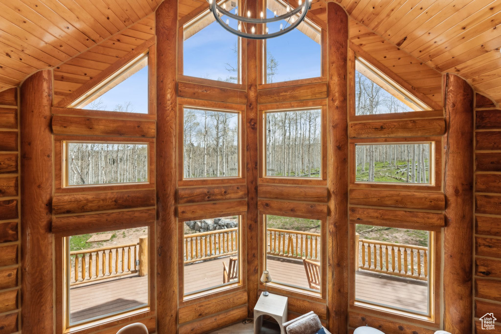 Detailed view of rustic walls, a chandelier, and wood ceiling