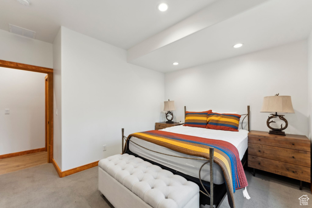 Bedroom featuring light carpet, recessed lighting, and baseboards