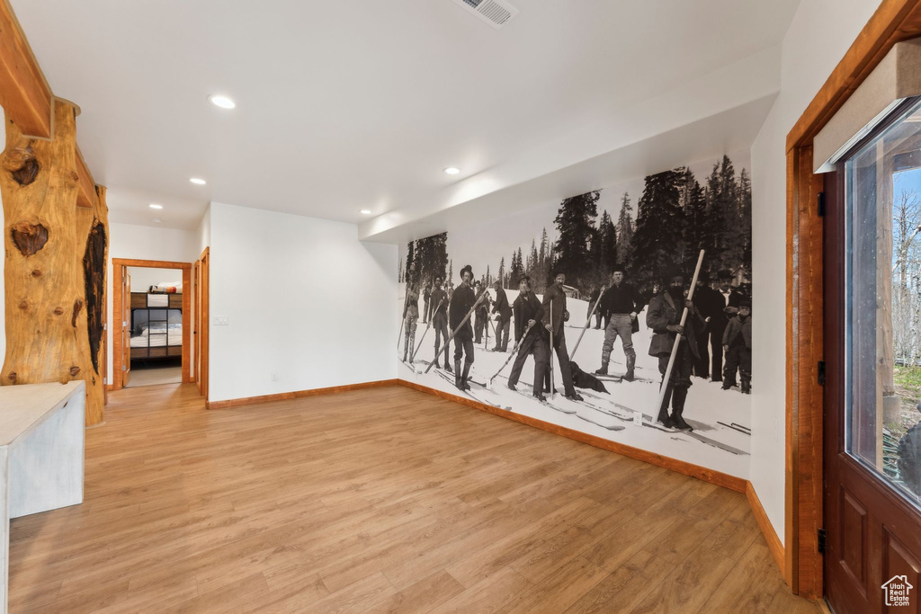 Unfurnished room featuring baseboards, light wood-style flooring, and recessed lighting