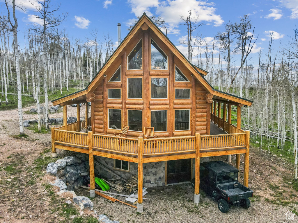 Rear view of house with a deck and log exterior