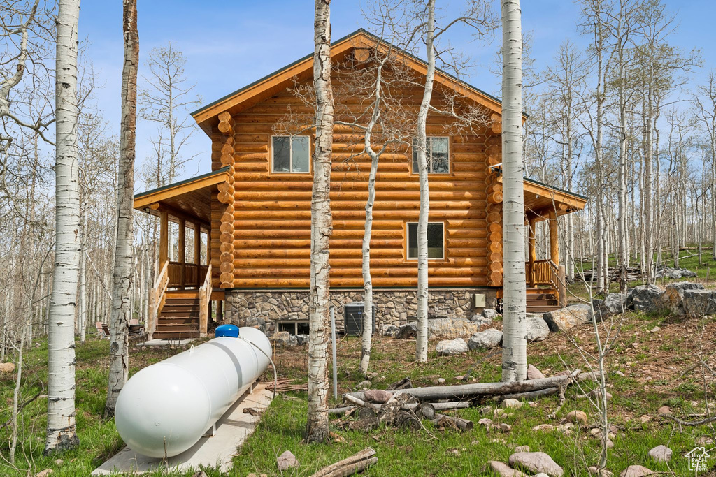 View of home's exterior featuring log exterior and stone siding