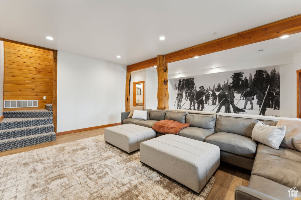 Living room with recessed lighting, wood finished floors, and baseboards