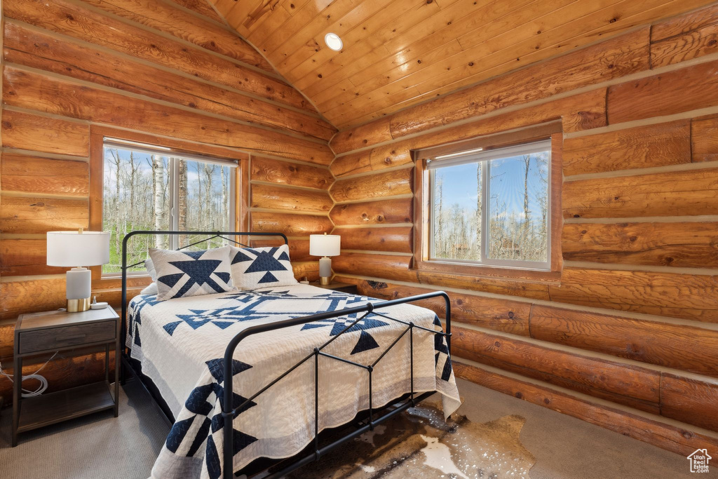 Bedroom with lofted ceiling, multiple windows, wooden ceiling, and carpet floors