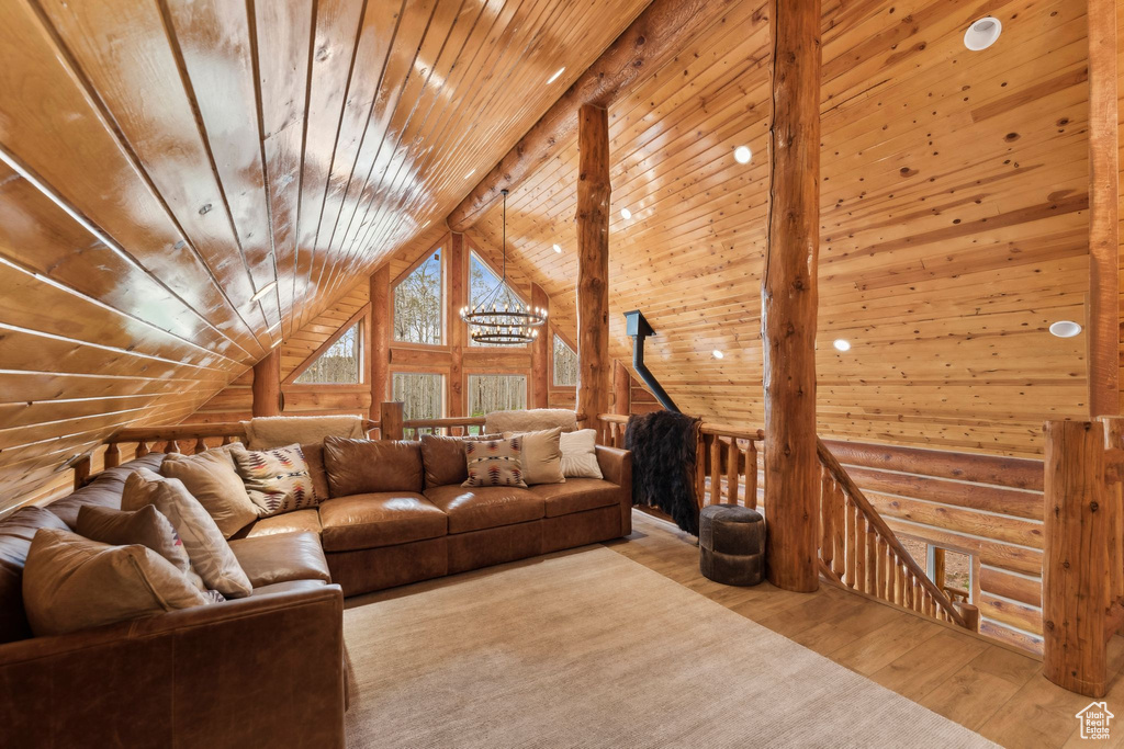 Living area with wood finished floors, wooden ceiling, rustic walls, vaulted ceiling, and wood walls
