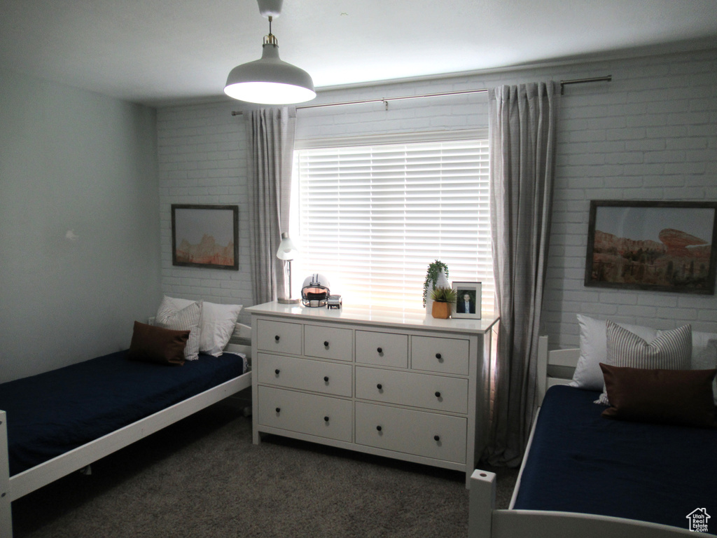 Bedroom featuring dark colored carpet