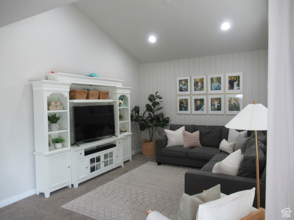 Living area featuring carpet flooring, vaulted ceiling, recessed lighting, and baseboards