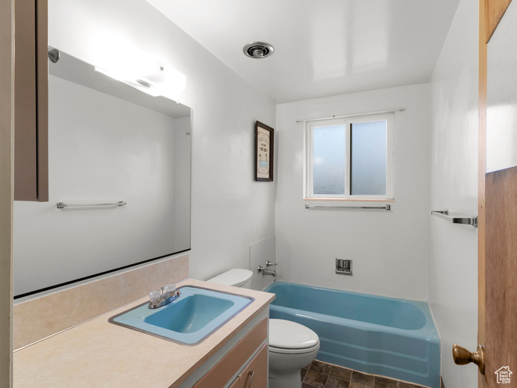 Bathroom with toilet, vanity, and a bathtub