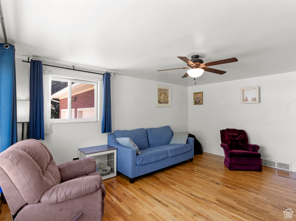 Living area featuring ceiling fan and light wood-style flooring