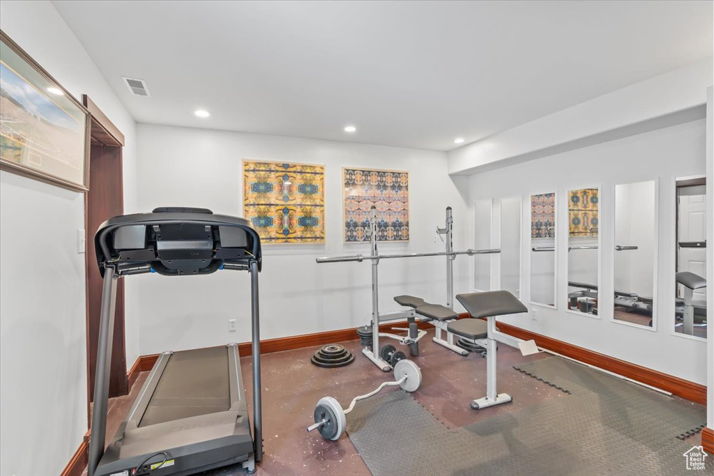Workout room featuring baseboards and recessed lighting