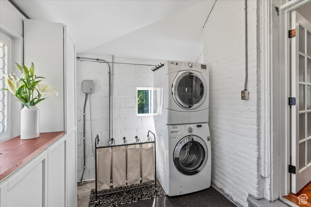 Laundry area with stacked washing machine and dryer