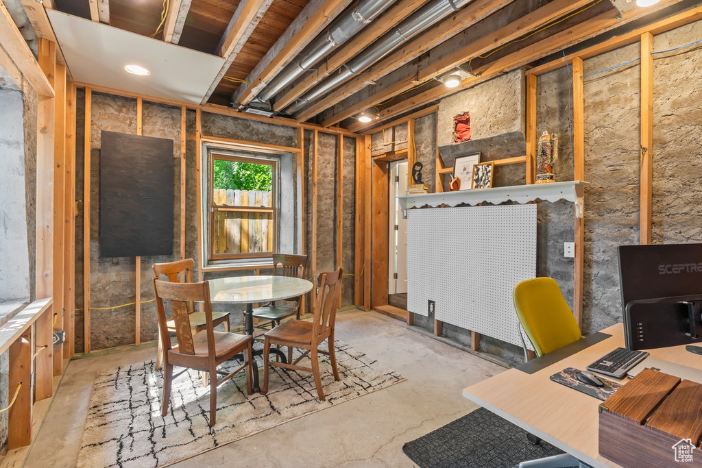 Dining area featuring unfinished concrete flooring