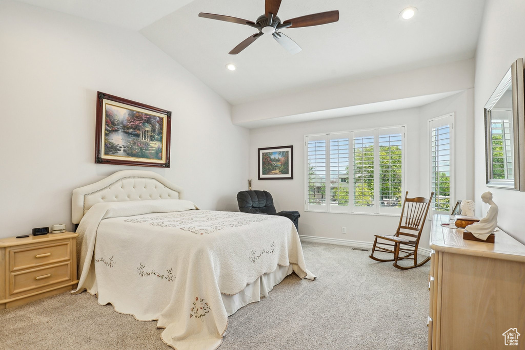 Bedroom featuring light colored carpet, vaulted ceiling, recessed lighting, baseboards, and a ceiling fan