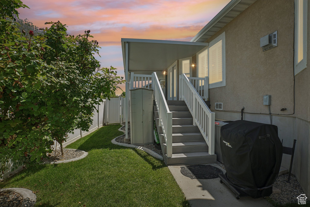 Entrance to property with stucco siding and an AC wall unit