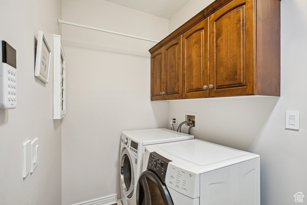Laundry room with cabinet space and separate washer and dryer