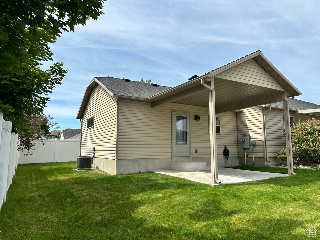 Rear view of house featuring a patio and central air condition unit
