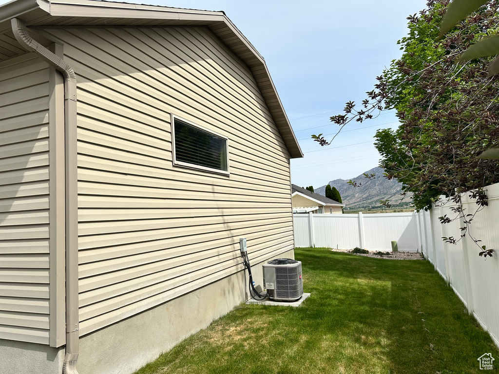 View of property exterior featuring central AC and a mountain view