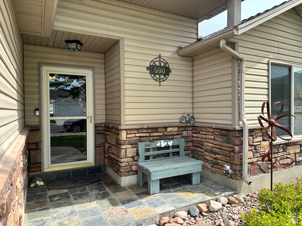 View of exterior entry featuring stone siding