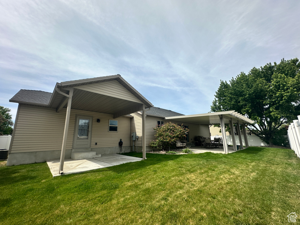Rear view of house featuring a patio area