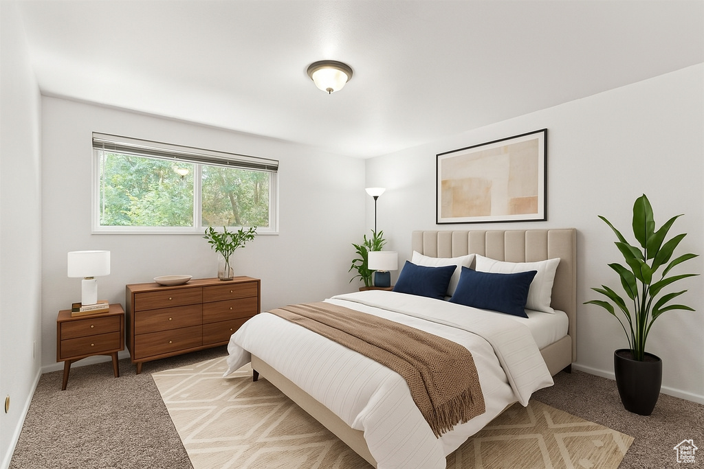 Bedroom featuring baseboards and light carpet