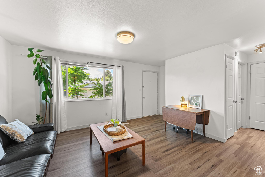 Living area featuring light wood-style floors and baseboards