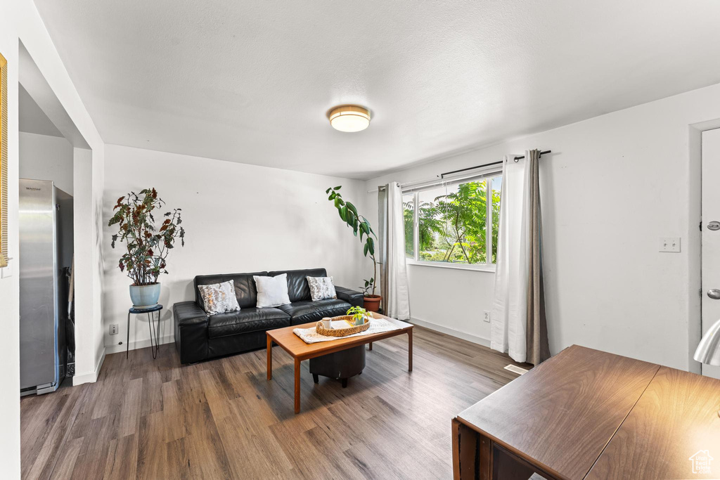 Living room with wood finished floors and baseboards