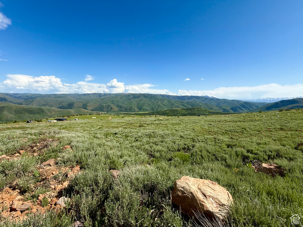 View of mountain backdrop featuring rural landscape