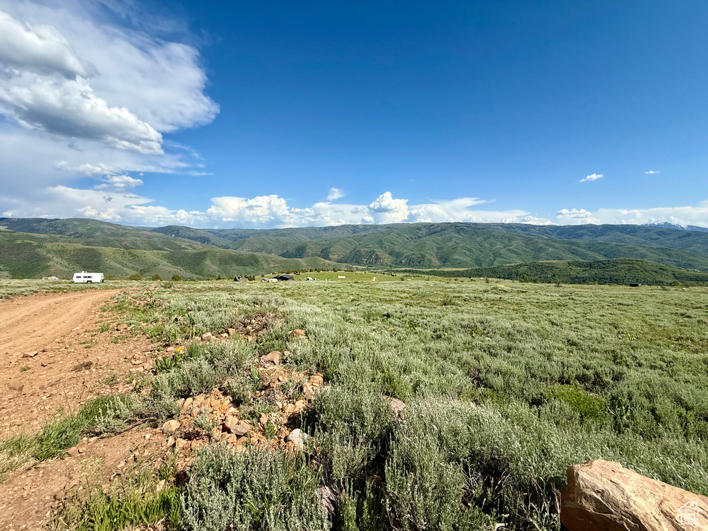 View of mountain backdrop with rural landscape