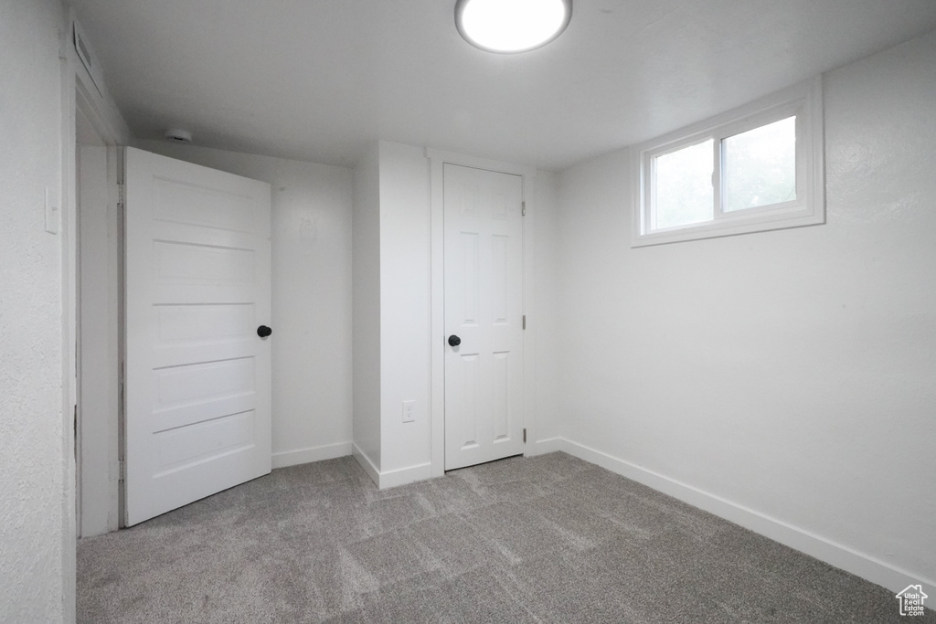 Below grade area featuring carpet flooring and baseboards