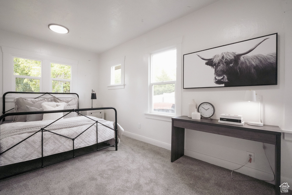 Bedroom featuring carpet floors and baseboards