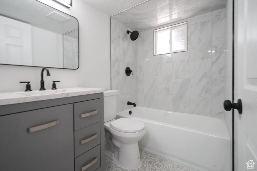 Full bathroom with vanity, toilet, tub / shower combination, and tile patterned flooring