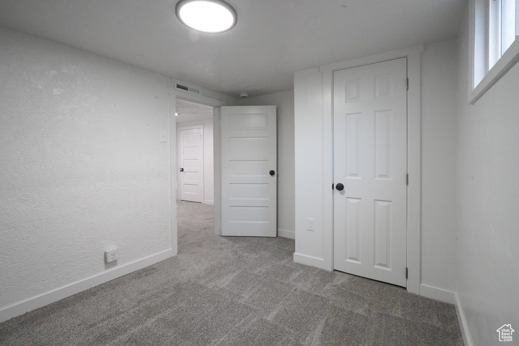 Unfurnished bedroom featuring carpet and baseboards