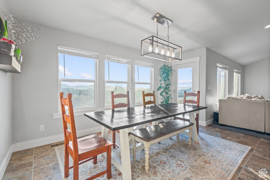 Dining room featuring baseboards and stone tile floors