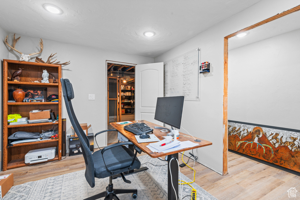 Office space with recessed lighting and light wood-type flooring