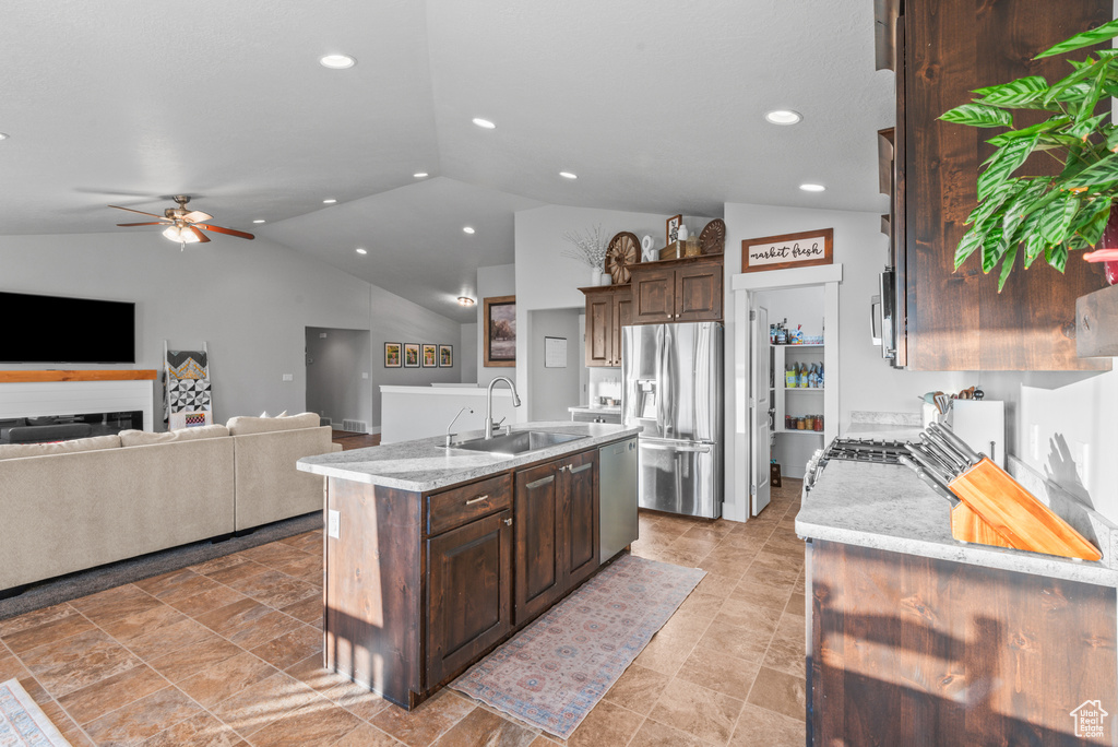 Kitchen featuring a sink, appliances with stainless steel finishes, lofted ceiling, recessed lighting, and a ceiling fan
