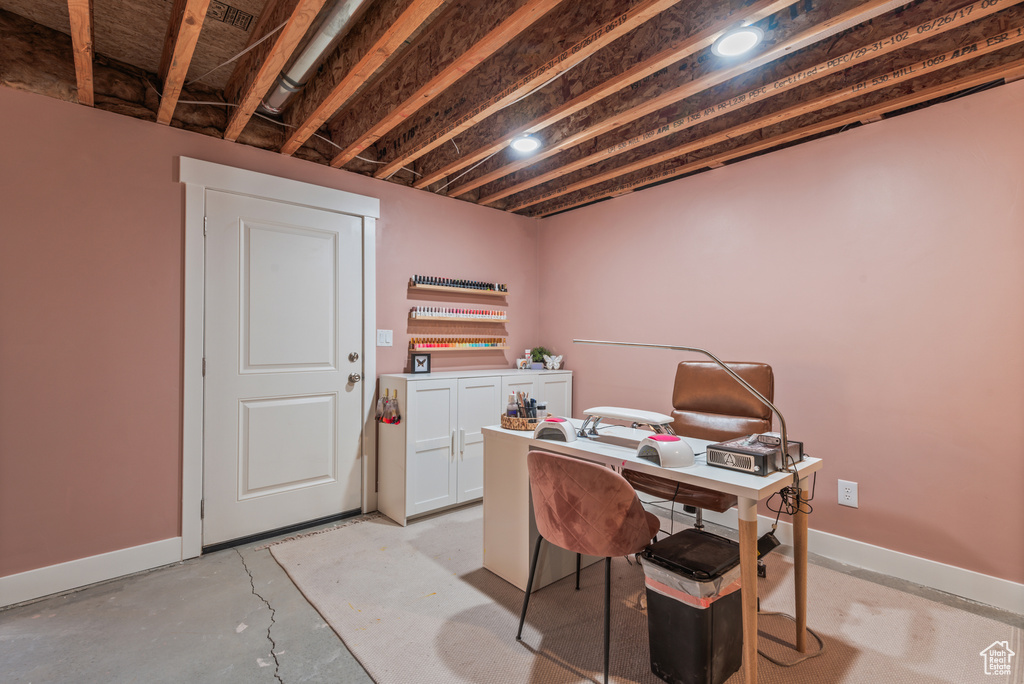Office space featuring concrete flooring and baseboards