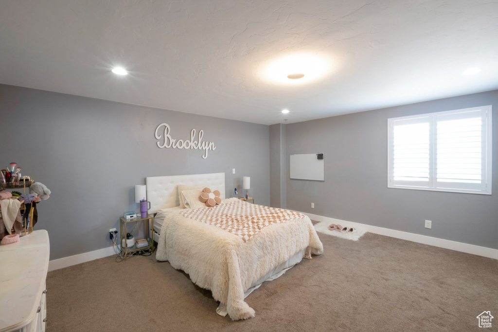 Bedroom featuring light carpet, baseboards, and recessed lighting