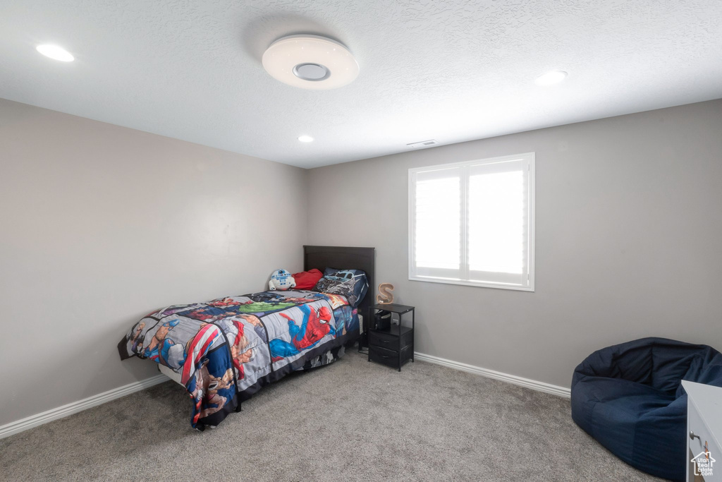 Bedroom featuring carpet, baseboards, recessed lighting, and a textured ceiling