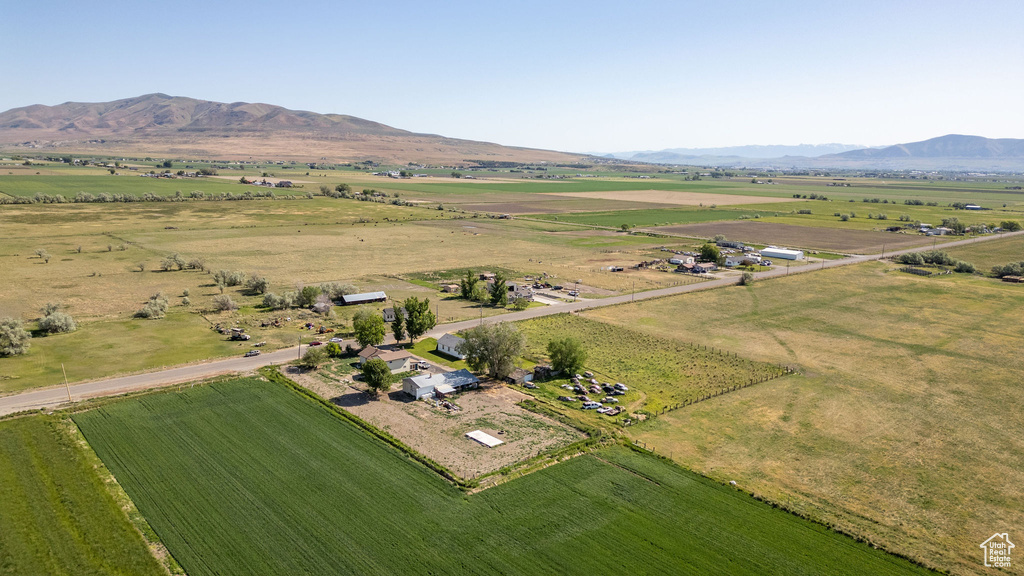 Overview of rural landscape with a mountain backdrop and rows of crops