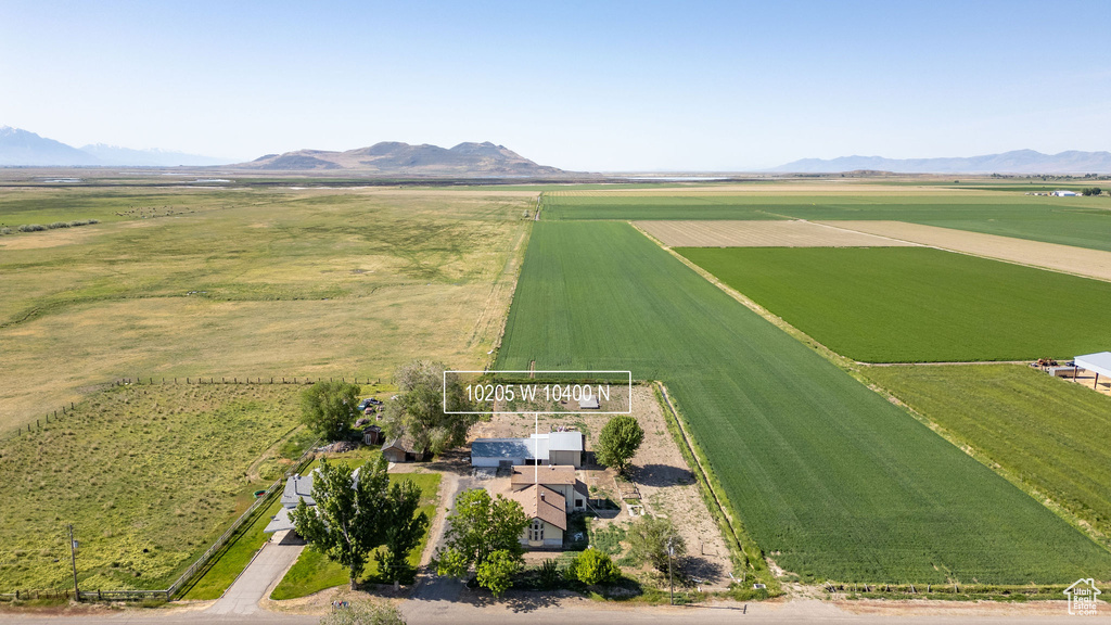 View of rural area featuring farmland and a mountainous background