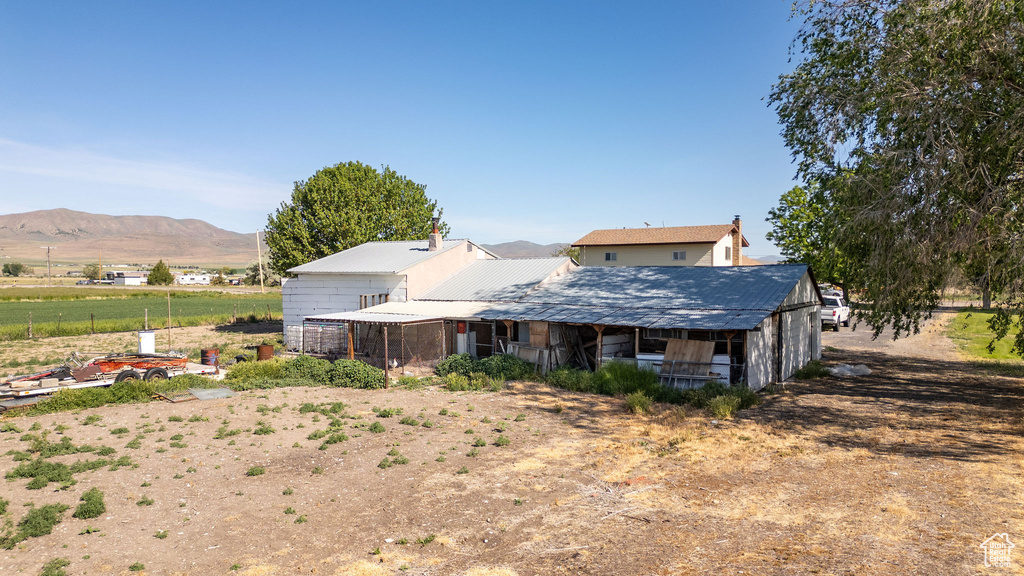 Back of property with a mountain view and metal roof