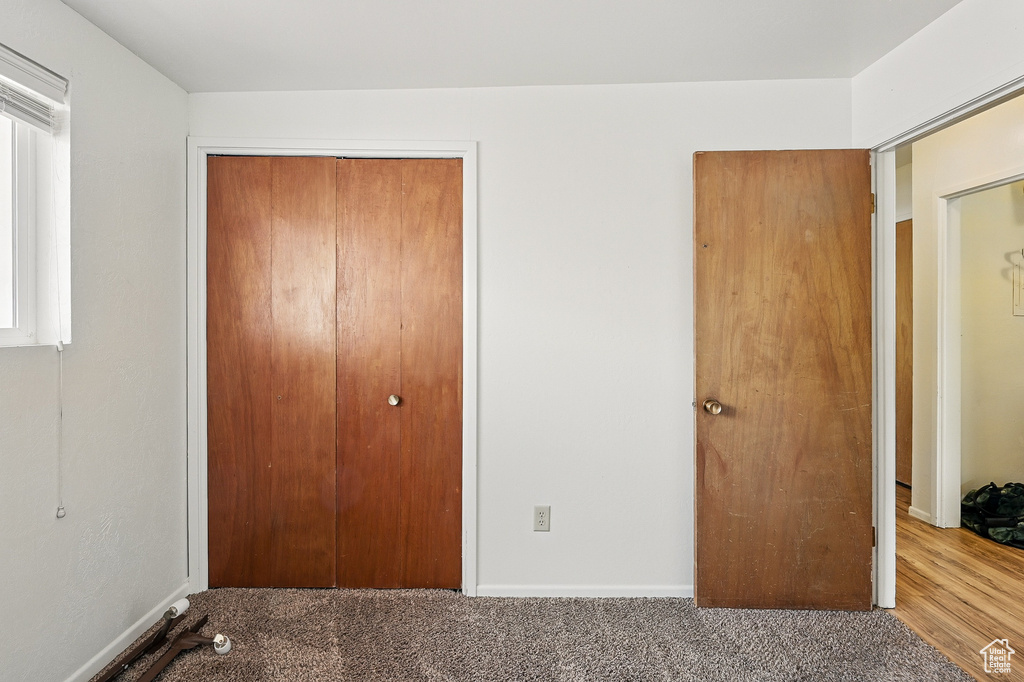 Unfurnished bedroom with a closet and carpet floors