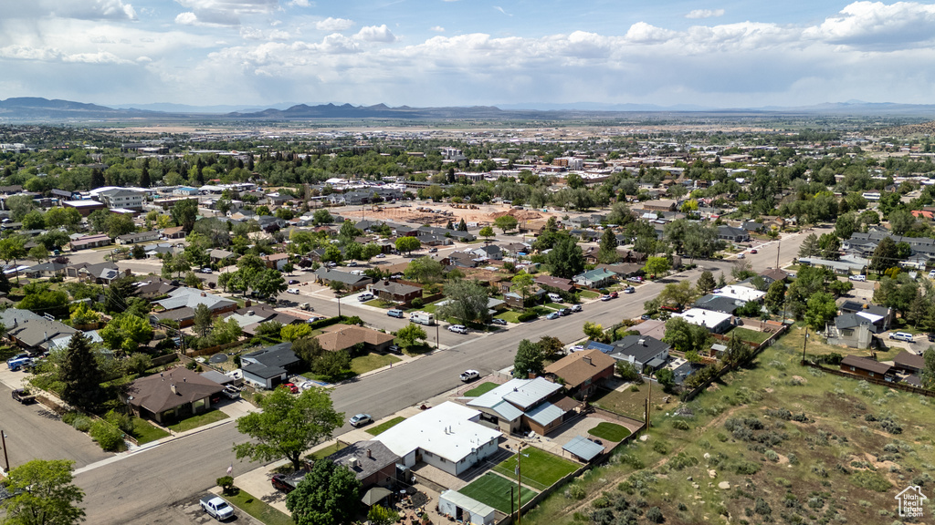 Aerial view of property's location with mountains and nearby suburban area