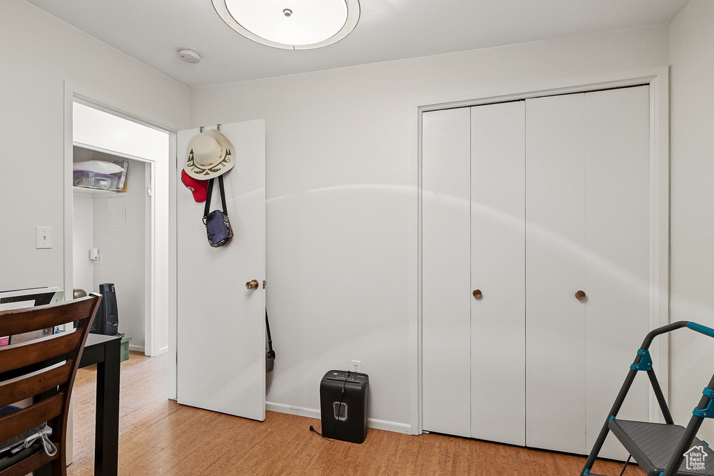 Unfurnished bedroom with light wood-type flooring, a closet, and baseboards