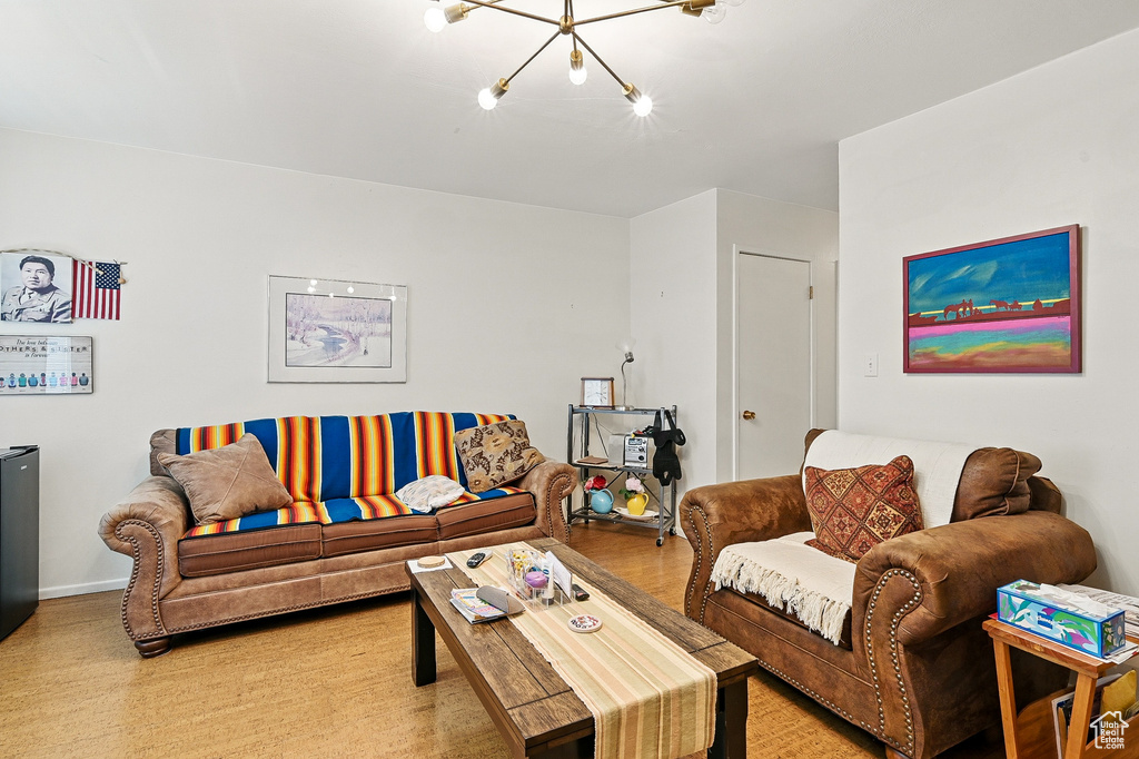 Living area with a chandelier and wood finished floors