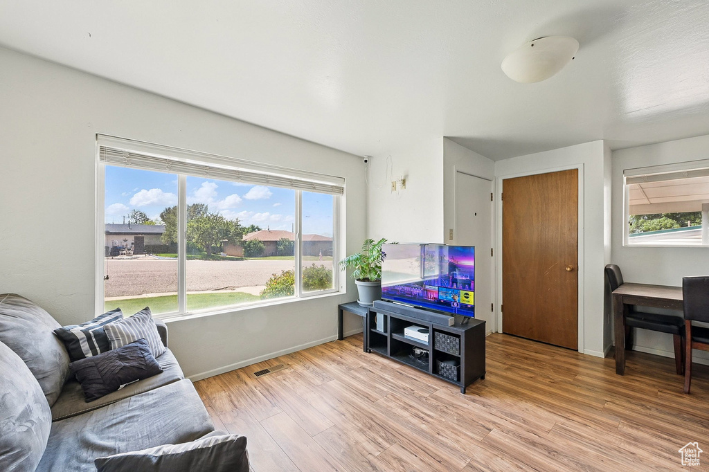 Living room featuring light wood-style flooring and baseboards